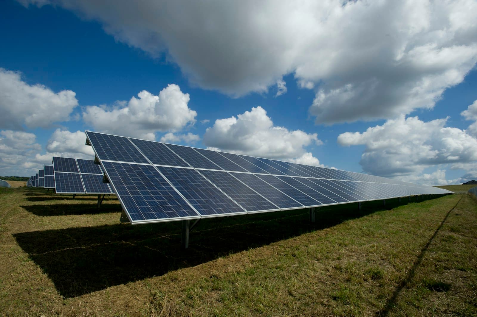 Rows of photovoltaic modules in bright sun, a soiling and irradiance context